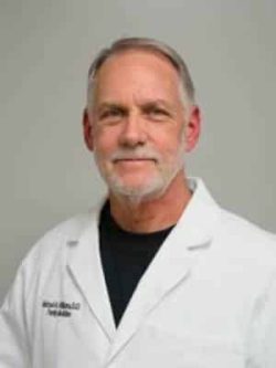 A Man Smiling For The Camera